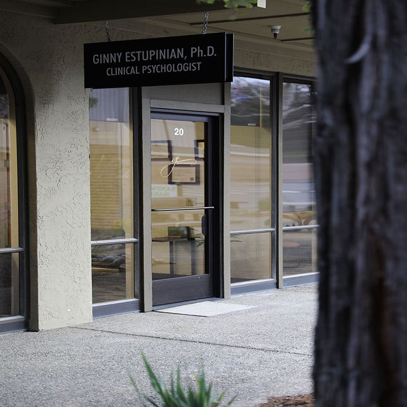 Image of the outside of the offices of Ginny Estupinian, PhD, ABPP, a Los Gatos psychologist. The professional shingle with the practice name is prominently hanging over the front door, with a clean, modern exterior and a welcoming entrance