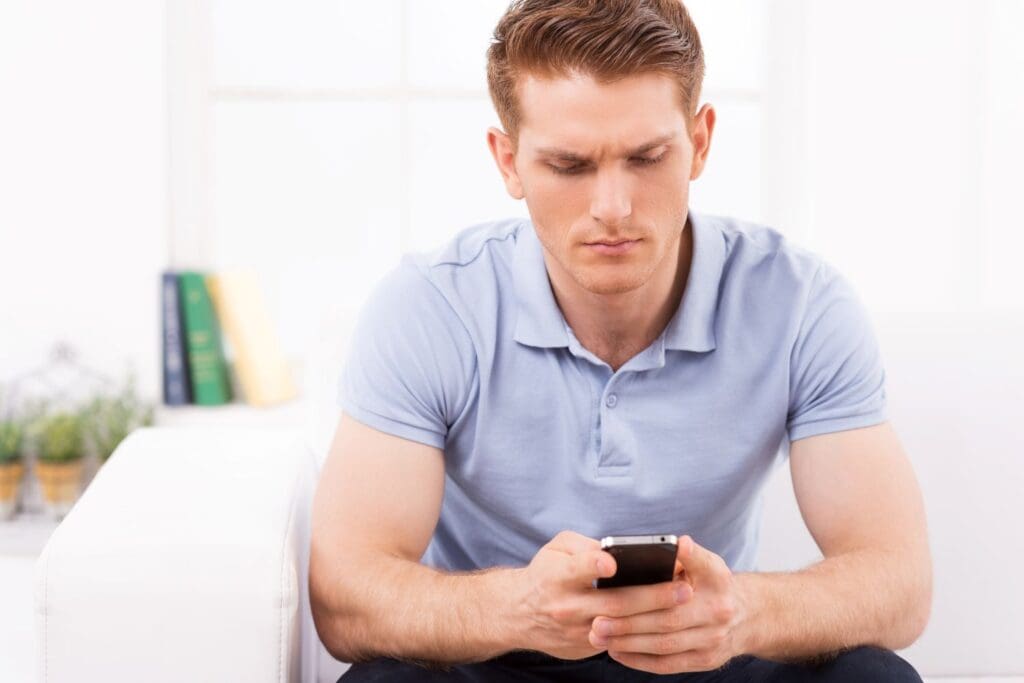 young man needing to take a break from mobil phone and news use