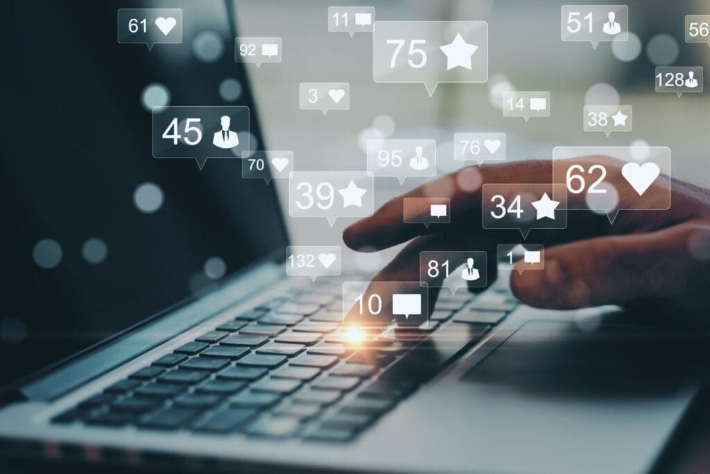 photo of a person on their computer with social media poping up