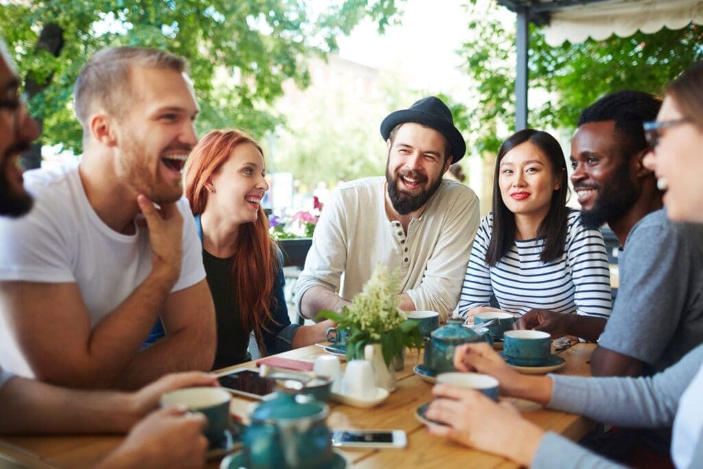 Photo of young adults socializing and building friendships, fostering connection and community.