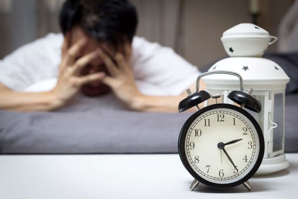 Photo of a Male awake unable to sleep in the middle of the night.