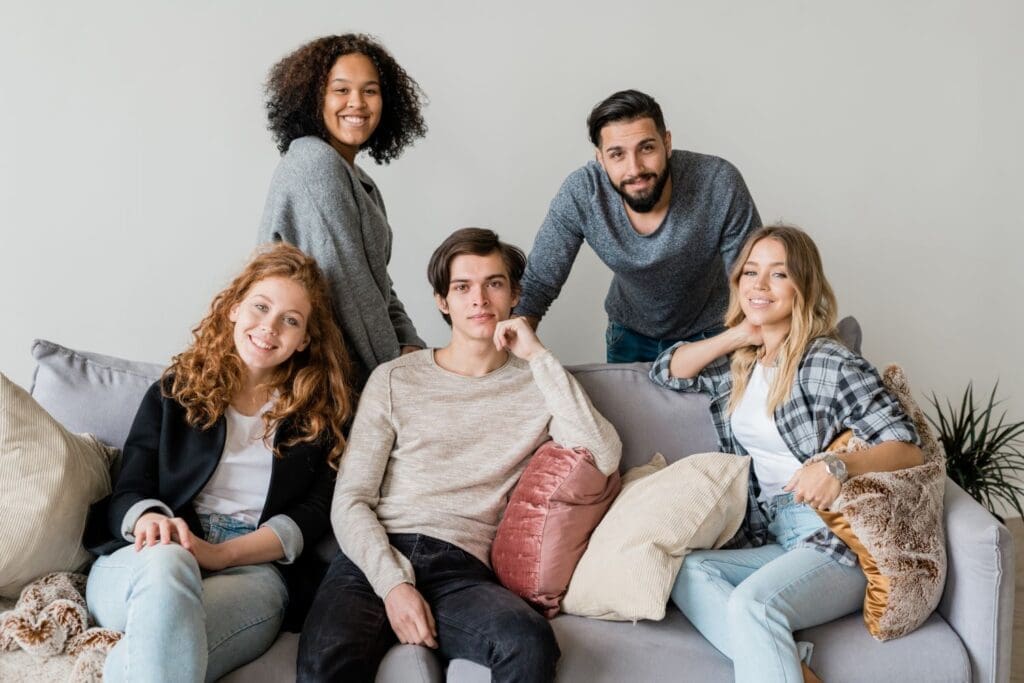 Photo of young adults sitting together. Ginny Estupinian PhD works with young adults by providing training in adulting and life skills