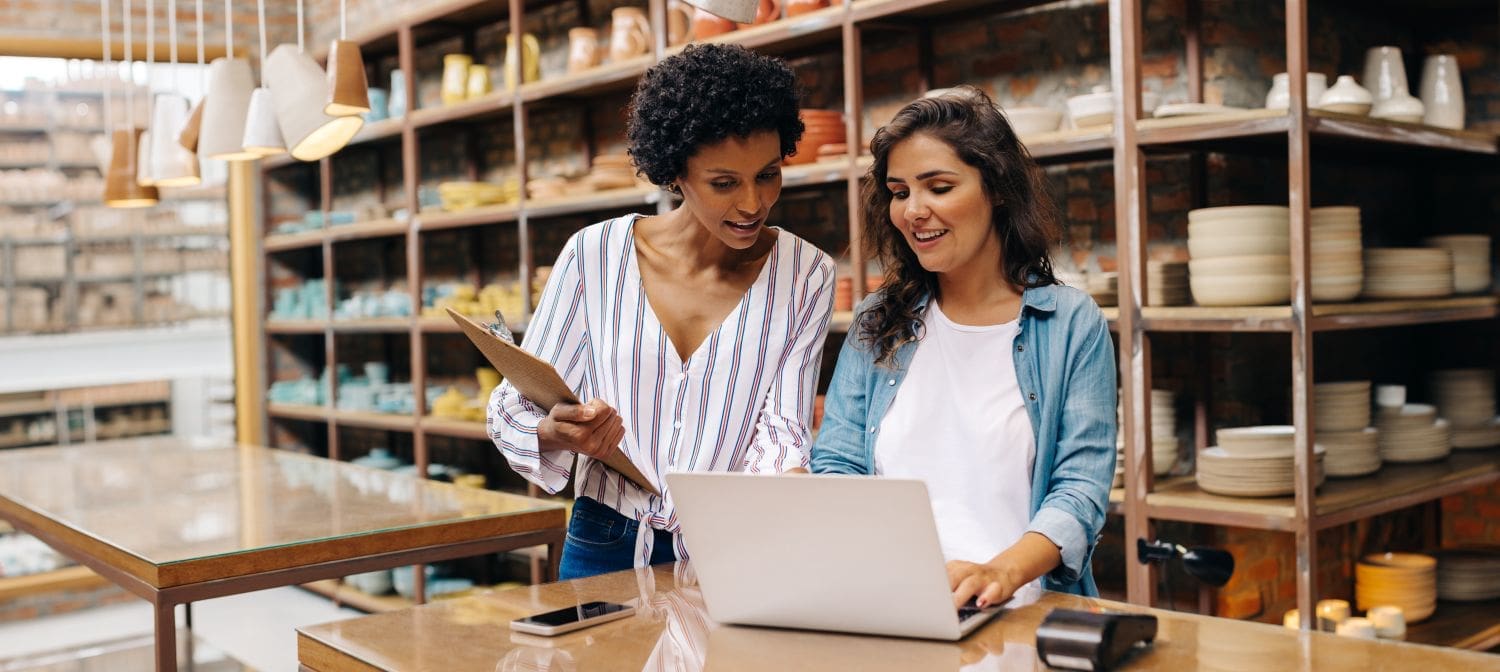 Small business owner and employee engaged in a performance review, applying leadership and feedback strategies taught by Ginny Estupinian, PhD, ABPP.