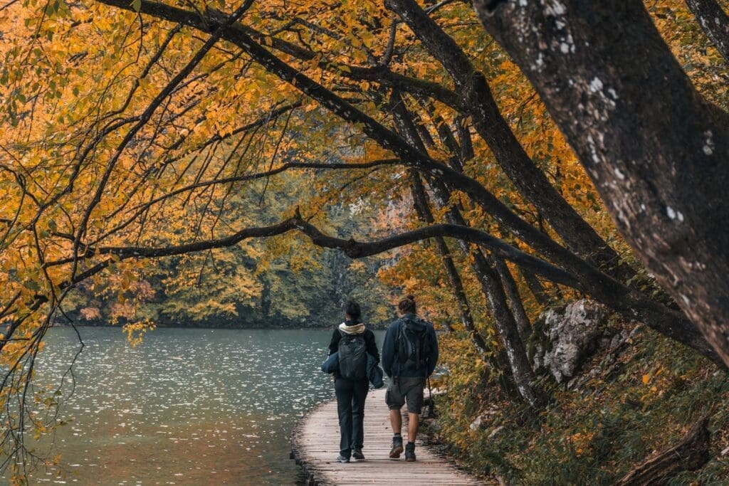 Photo of a man and woman walking in nature and experiencing awe.